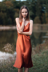 Woman wearing orange silk Closet classic dress outdoors